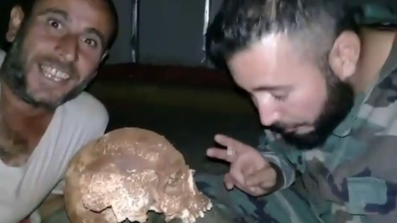 Esed rejimi askerleri mezardan kafatası çıkartıp video çekti